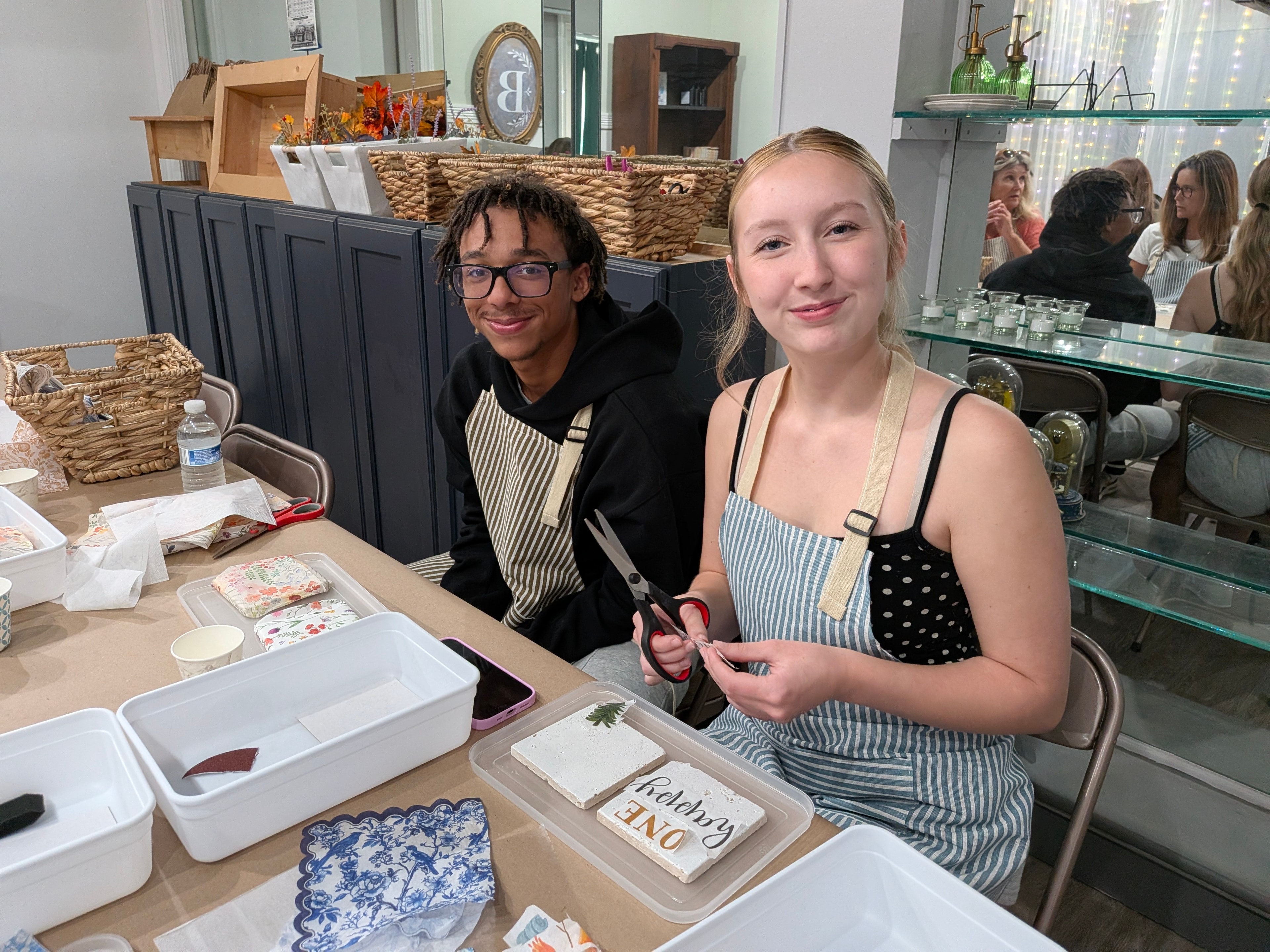 Three women showing off their decorated craft boxes at Barnstone Studio